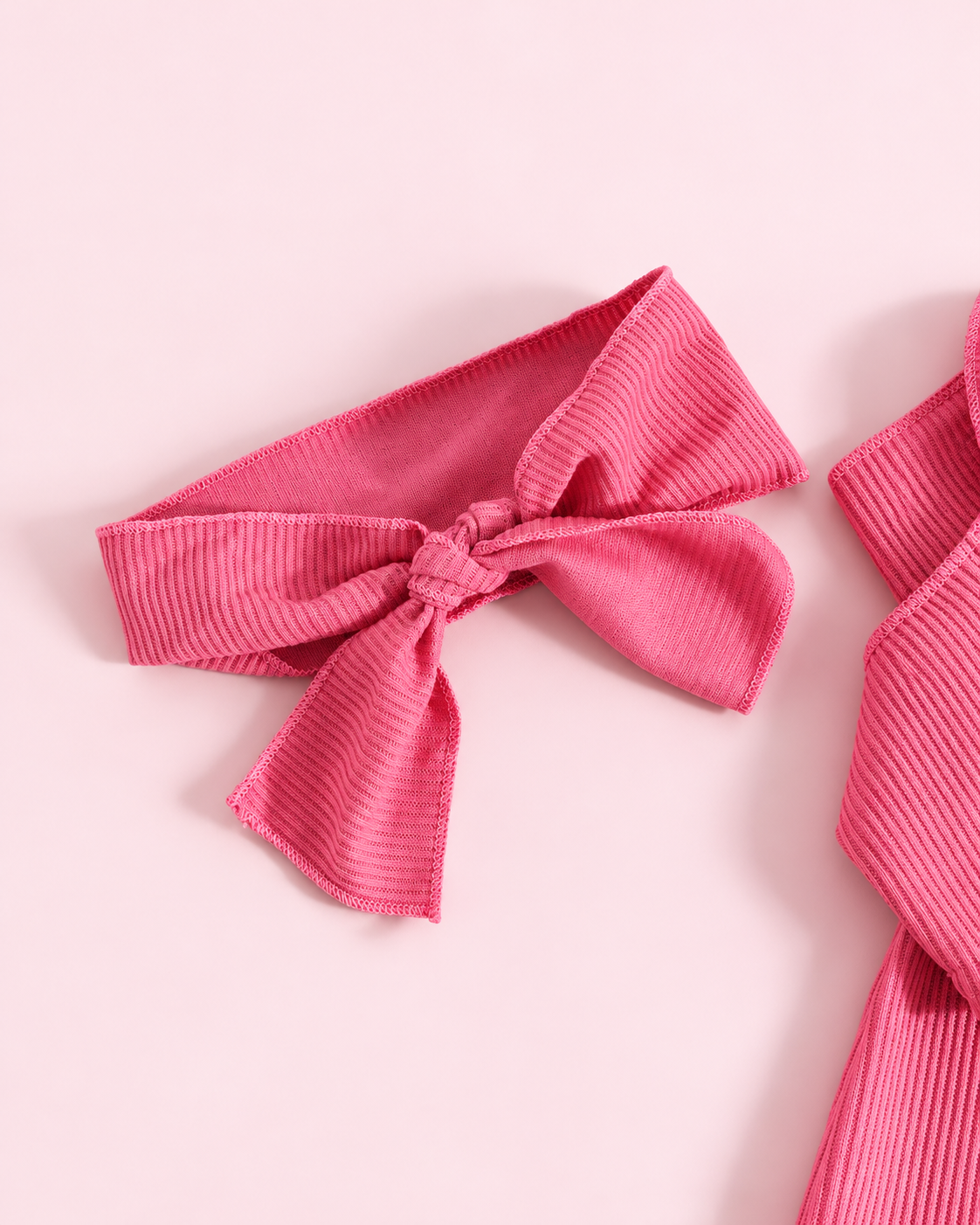 Matching hot pink ribbed tied bow headband detail