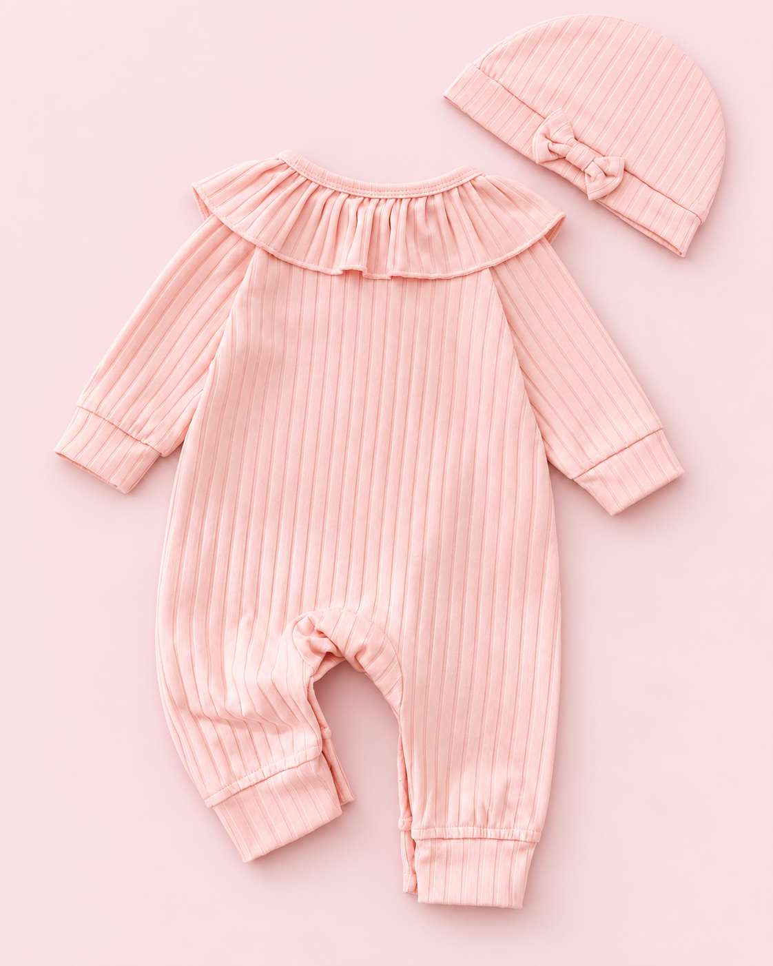 Back view of light pink ribbed romper and matching bow cap