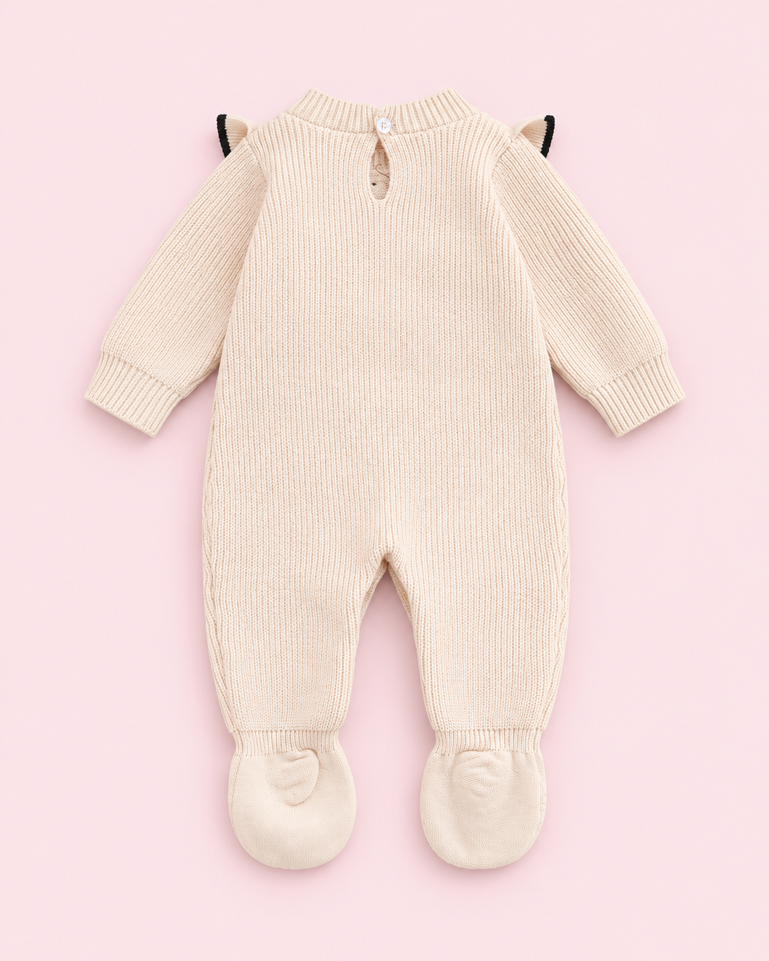 Back view of apricot knitted footed romper