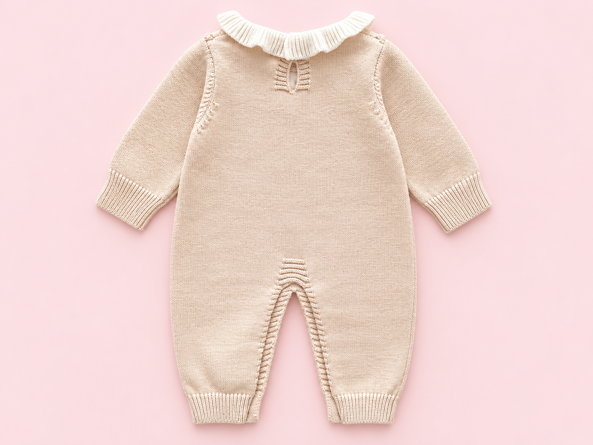 Beige knitted baby romper back detail on blush pink