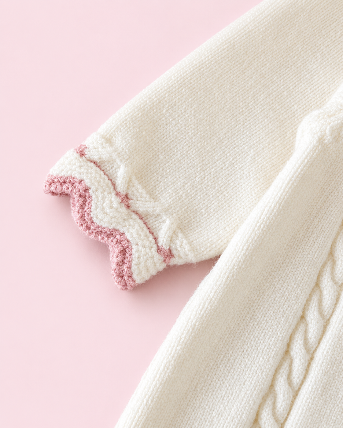 Cream romper pink scalloped cuff and cable knit detail