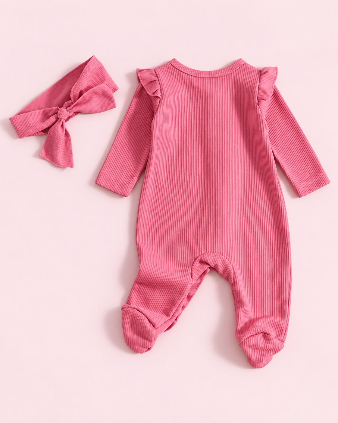 Back view of hot pink ribbed footed romper with matching headband